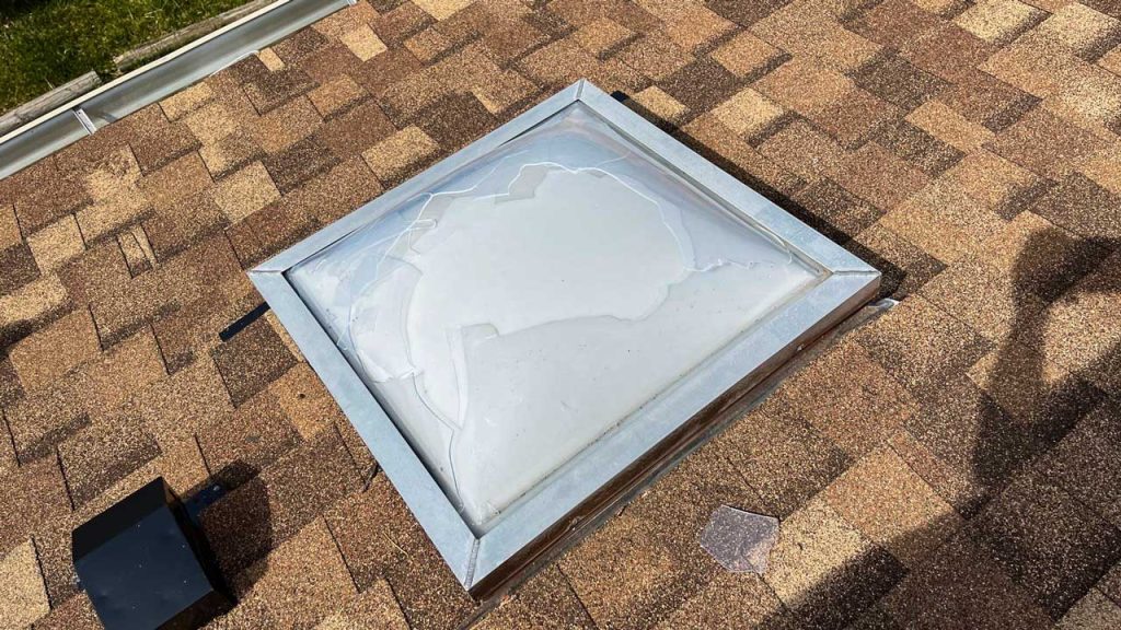 An image showing a hail damaged skylight.