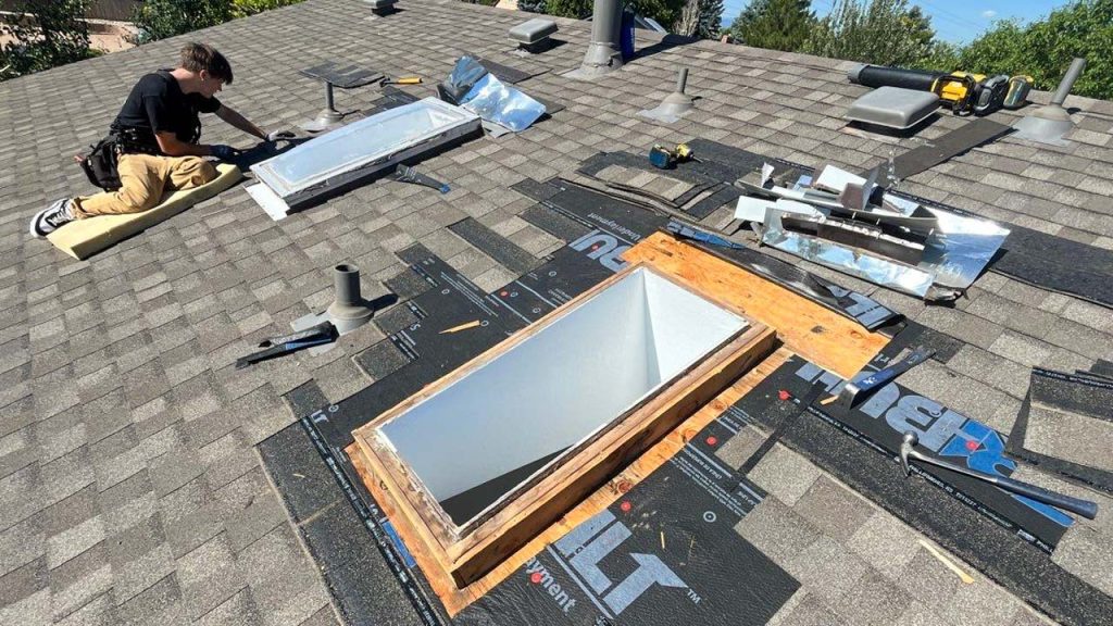 Our technician is removing shingles around the dome skylight.