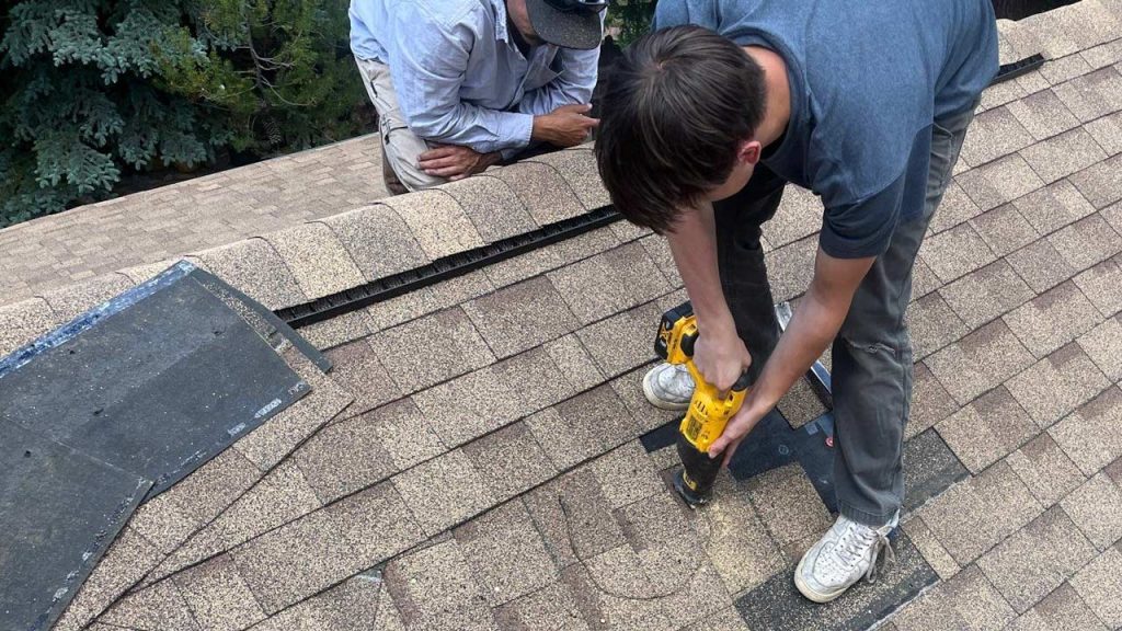 An image of a technician cutting a hole in the roof.