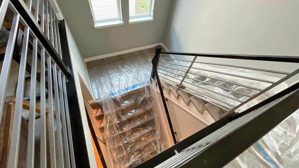 A stairwell protected with plastic sheeting.