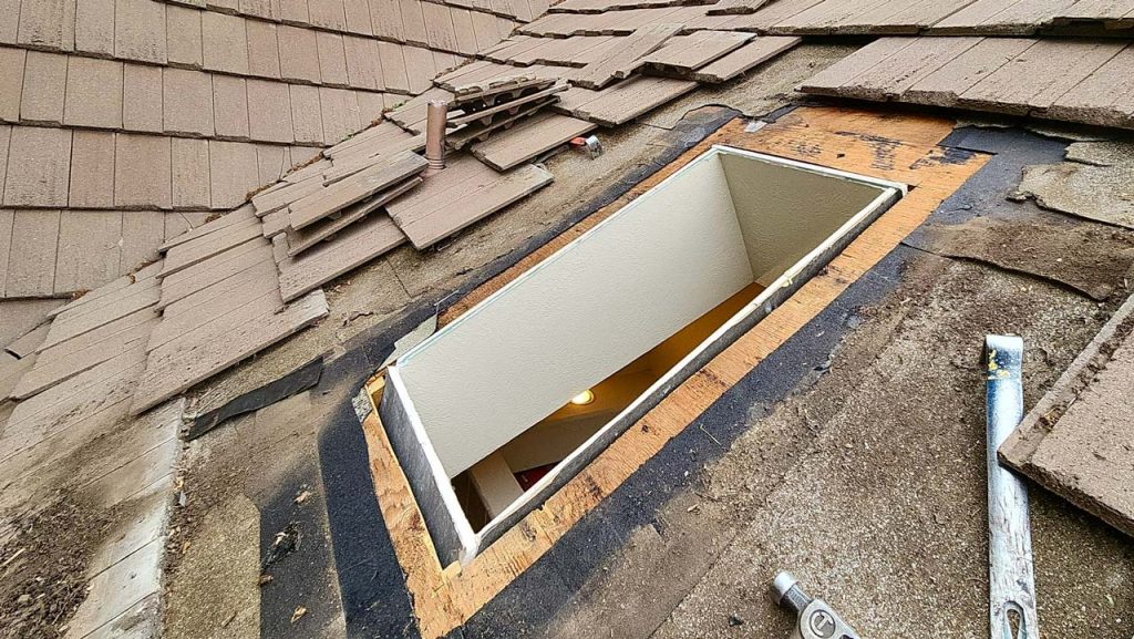 Tiles have been removed from the area and the old skylight is gone.