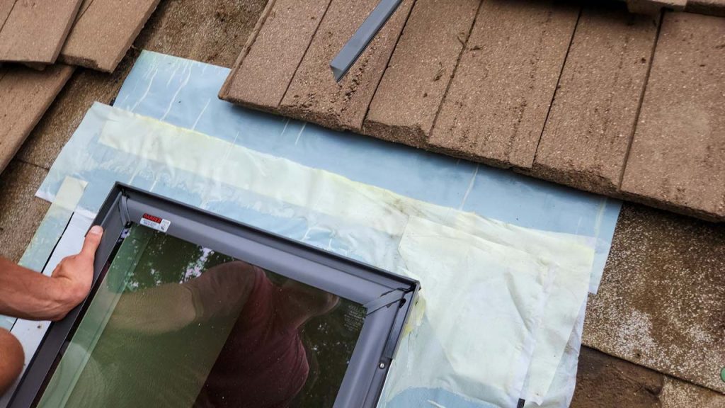 The new skylight is surrounded with underlayment prior to flashing.