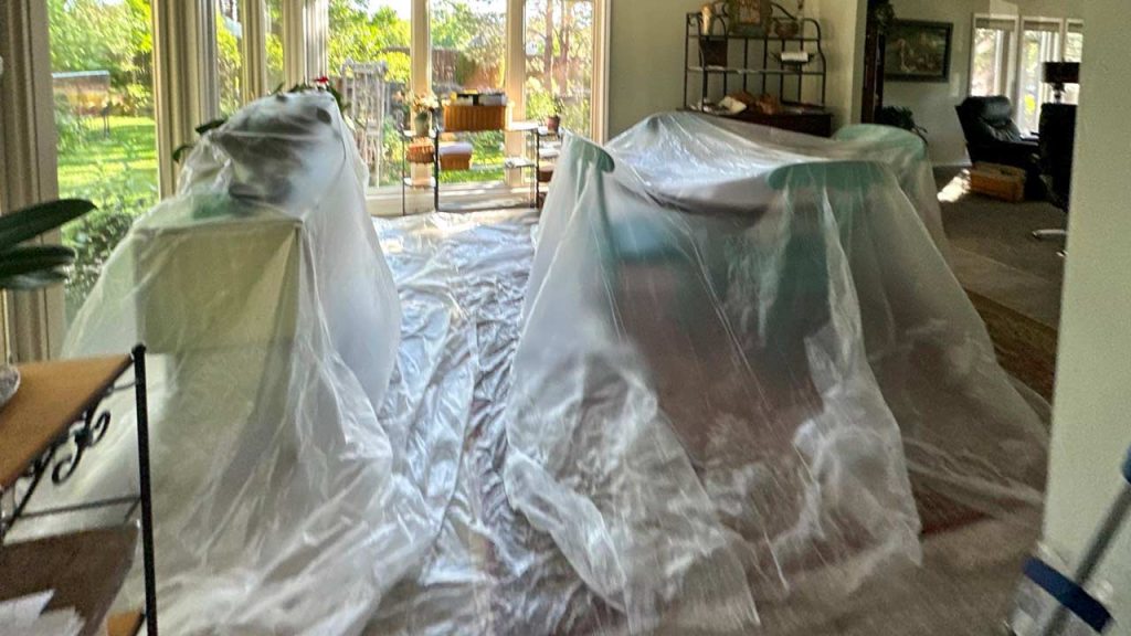 Plastic sheeting protects the room from dust and debris.