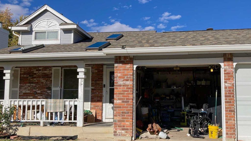 An image showing a street view of the home with the new skylights.