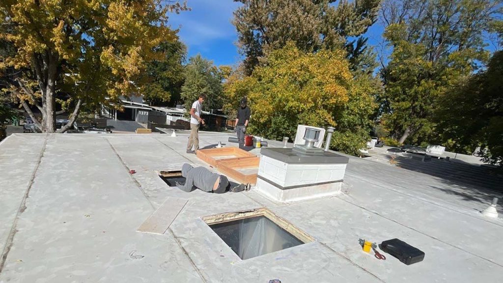 An image showing the two holes cut in the roof deck for the new skylights,