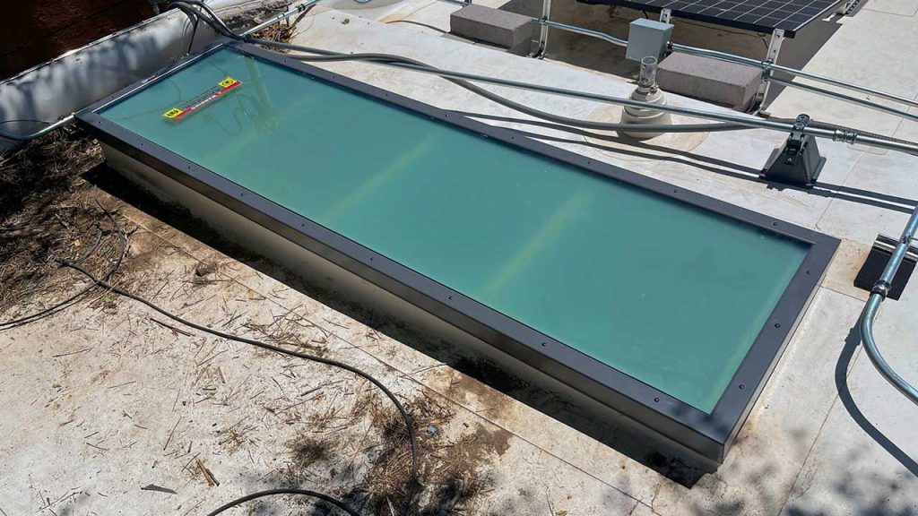 An image of the 2 foot by 8 foot replacement glass skylight on the roof.