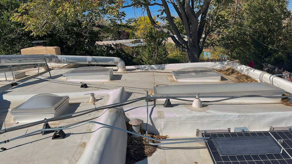 An image of five of the six acrylic dome skylights on the roof.