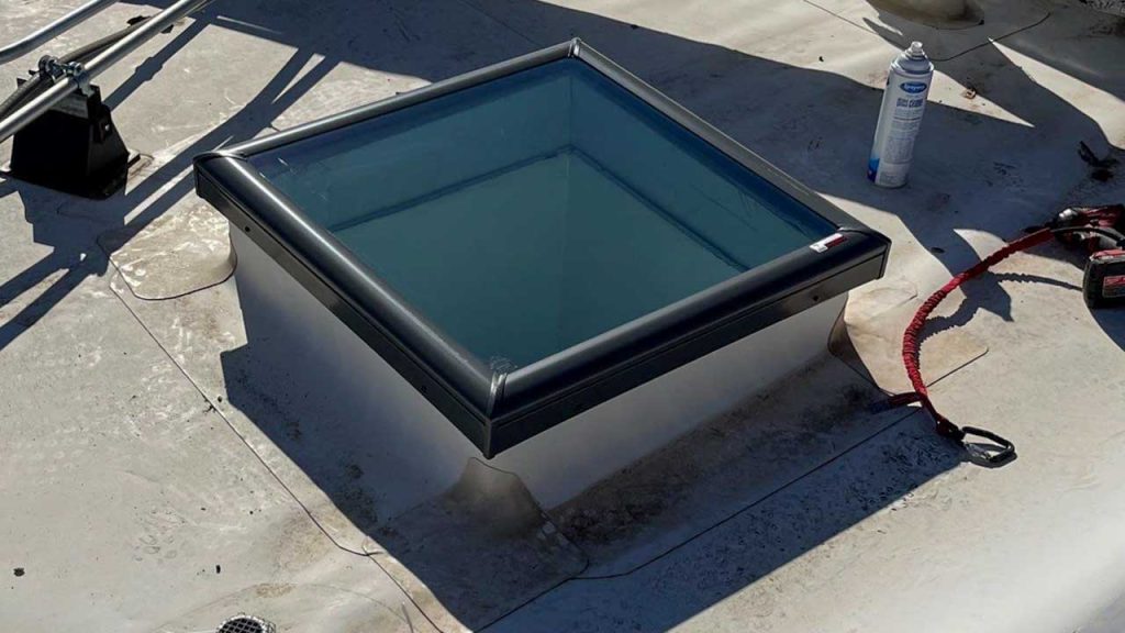 An image of one of the 2 foot by 2 foot replacement glass skylight on the roof.