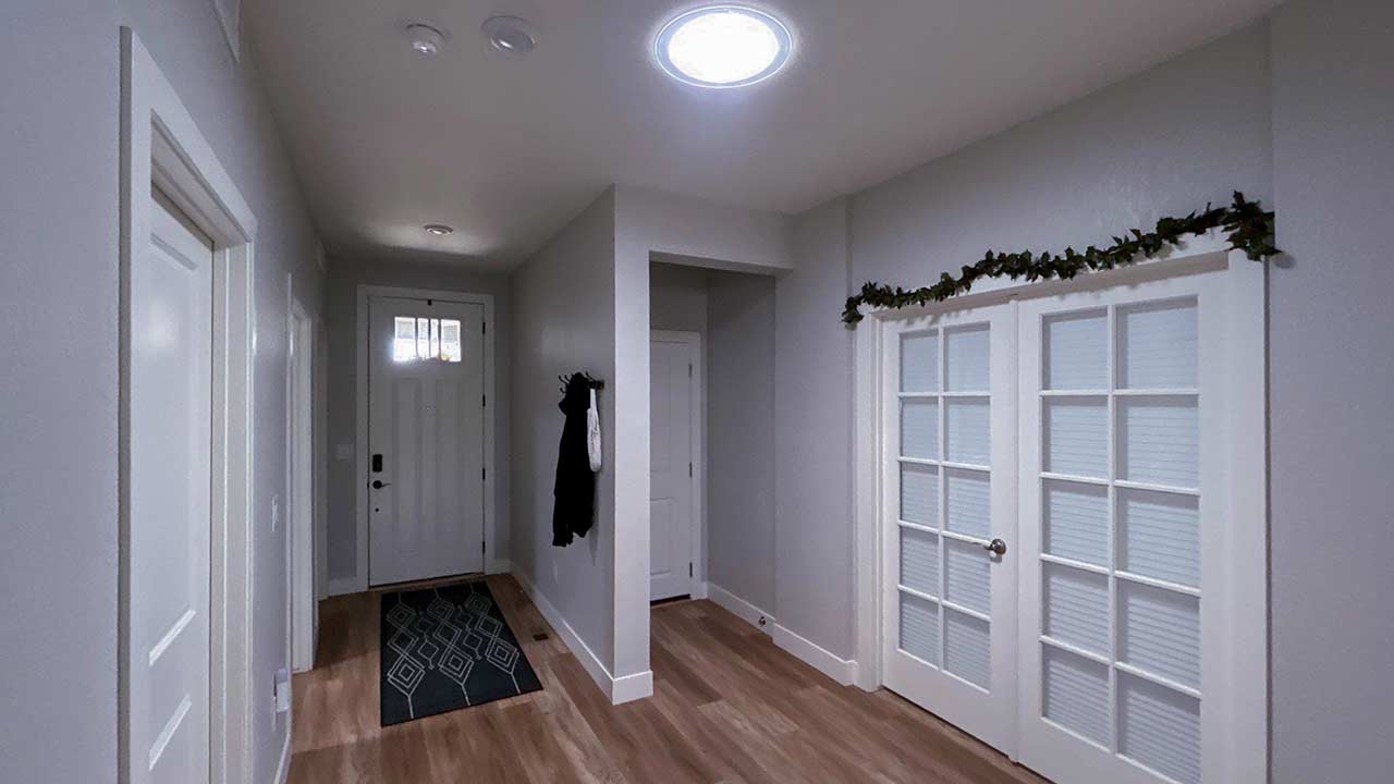 An entryway with a Velux Sun Tunnel.