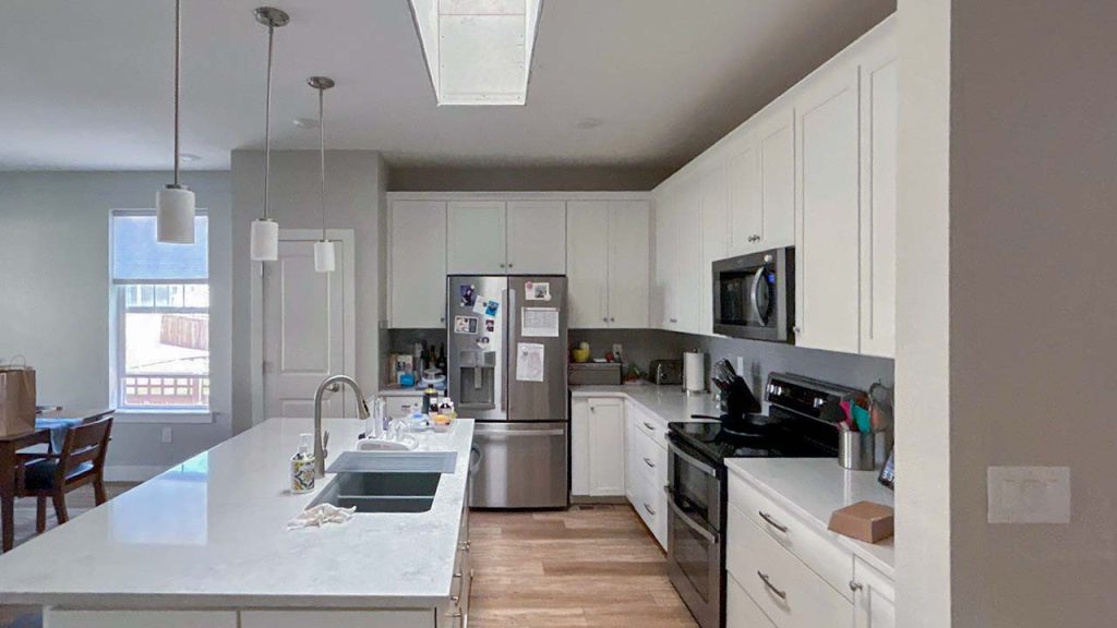 Aview of a kitchen with a Velux skylight.