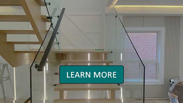 Modern staircase with wooden steps and glass railings, illuminated by soft LED lights. A large window on the right provides natural light. Learn More overlay.