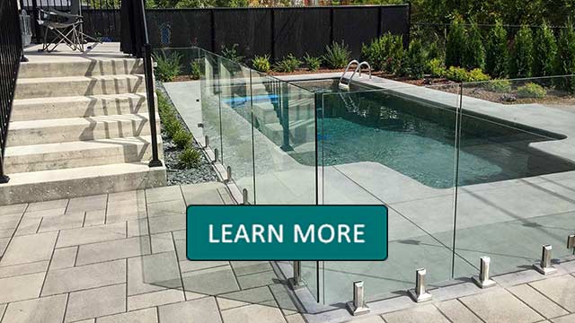 Modern staircase with wooden steps and glass railings, illuminated by soft LED lights. A large window on the right provides natural light. Learn More overlay.